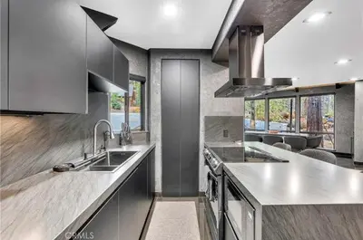 a kitchen with stainless steel counter tops and appliances at Modern Mountain Luxury Soak, Stay, & Be Spoiled in Shaver Lake