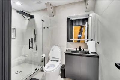 a bathroom with a toilet and a sink and a shower at Modern Mountain Luxury Soak, Stay, & Be Spoiled in Shaver Lake