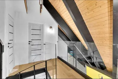 a staircase in a house with a wooden ceiling at Modern Mountain Luxury Soak, Stay, & Be Spoiled in Shaver Lake