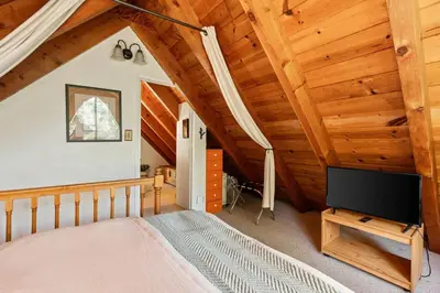 a bedroom with a bed and a flat screen tv at Piece of Paradise Dream Deck AC in Shaver Lake