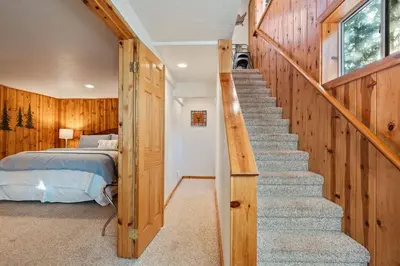 a staircase leading to a bedroom with a bed at Piece of Paradise Dream Deck AC in Shaver Lake
