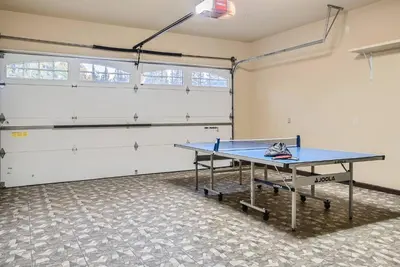 a ping pong table in a room with a tennis court at Beautiful Granite Bay Home near Folsom Lake in Granite Bay