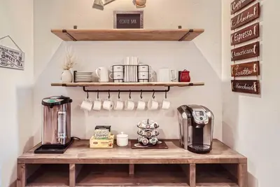 a coffee shop with a shelf with cups and a coffee maker at Beautiful Granite Bay Home near Folsom Lake in Granite Bay