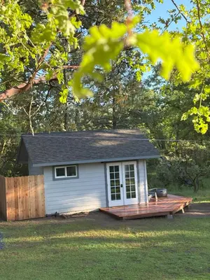 a small shed with a deck in a yard at The Mountains are Calling - Private, Guesthouse Retreat near Yosemite in Ahwahnee