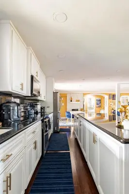 a kitchen with white cabinets and a counter top at Memorable Moment at Placid Blue with Pool & Hot Tub in Sacramento