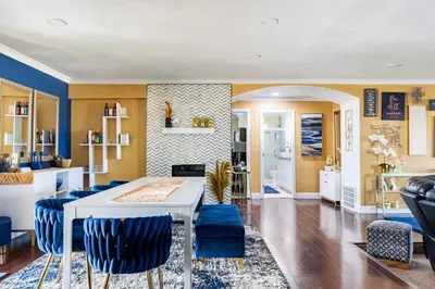 a living room with a white table and blue chairs at Memorable Moment at Placid Blue with Pool & Hot Tub in Sacramento