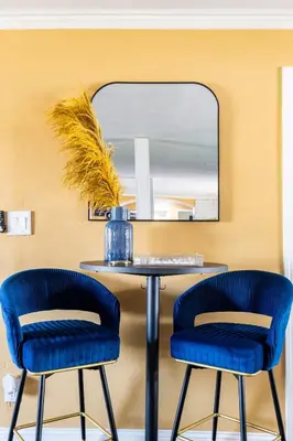 two blue chairs and a table with a mirror at Memorable Moment at Placid Blue with Pool & Hot Tub in Sacramento