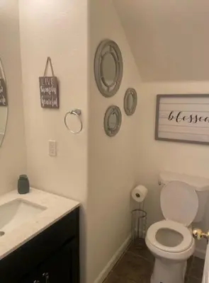 a bathroom with a white toilet and a sink at Spacious 4 bedroom house! in Stockton