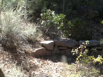 a stone wall on the side of a hill at Modern Woodland Cabin Getaway with a Fireplace in Truckee, California in Truckee