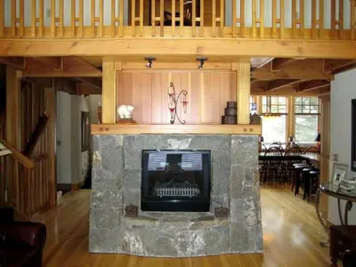 a living room with a stone fireplace in a house at Modern Woodland Cabin Getaway with a Fireplace in Truckee, California in Truckee