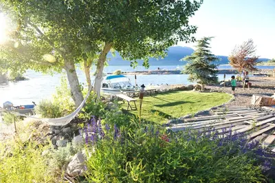 a hammock in a garden next to the water at Rustic Trailer Rental on the Shores of Bridgeport Reservoir, California in Bridgeport