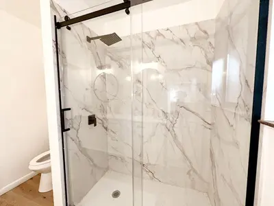 a shower with a glass door in a bathroom at Fabulous Glamping Spot in Truckee, California: Charming Cabin near Lake Donner in Truckee