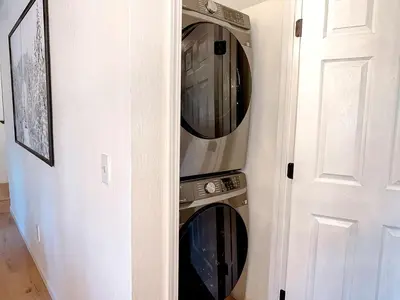 two washer and dryer in a wall next to a door at Fabulous Glamping Spot in Truckee, California: Charming Cabin near Lake Donner in Truckee