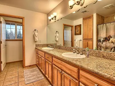 a bathroom with two sinks and a large mirror at Gorgeous Vacation Rental with Hot Tub near Yosemite National Park, California in Mariposa