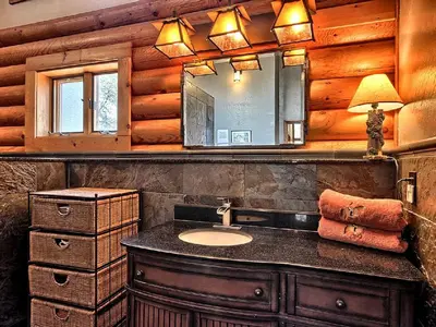 a bathroom with a sink and a mirror at Cozy Log Cabin near Yosemite National Park in California in Mariposa