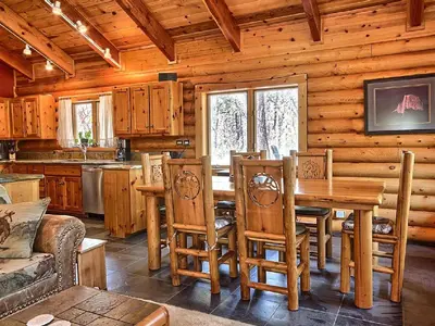 a kitchen with a table and chairs in a cabin at Cozy Log Cabin near Yosemite National Park in California in Mariposa