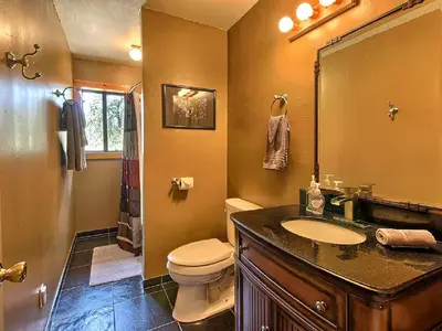 a bathroom with a toilet and a sink and a mirror at Family-Friendly Cabin near Yosemite National Park in California in Mariposa