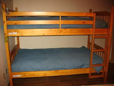 two bunk beds in a room with a blue bed at Exceptional Riverside Cabin Rental in the Trees near Pinecrest Lake, California in Strawberry