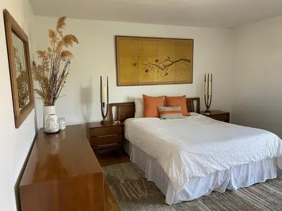 a bedroom with a bed and two tables at Magical property in the Alabama Hills - HOT TUB in Lone Pine