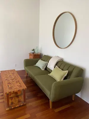 a green couch in a living room with a mirror at 3 B 2 BA home in a Serene, quiet cul de sac in Lone Pine