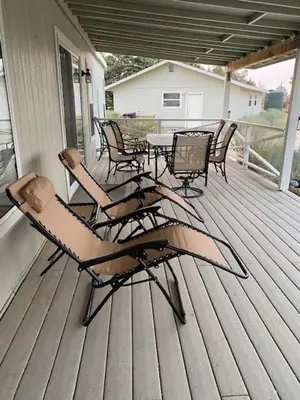 a patio with chairs and a table on a porch at 3 B 2 BA home in a Serene, quiet cul de sac in Lone Pine