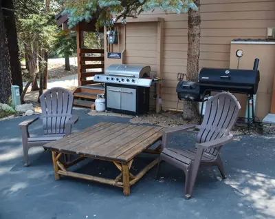 two chairs and a picnic table and a grill at San Sierra #16 Hot Tub Sauna Near Skiing in Mammoth Lakes