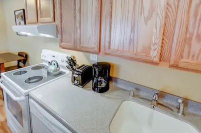 a kitchen counter with a stove and a sink at San Sierra #16 Hot Tub Sauna Near Skiing in Mammoth Lakes