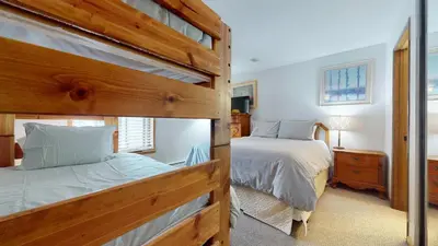 a bedroom with two beds and a bunk bed at Serene Sierra Sanctuary Experience Mammoth Magic in Mammoth Lakes