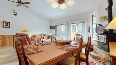 a dining room with a table and a living room at Serene Sierra Sanctuary Experience Mammoth Magic in Mammoth Lakes