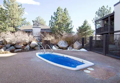 a bath tub sitting in the driveway of a house at Sherwin Villas #63 Private Deck & Near Lakes in Mammoth Lakes