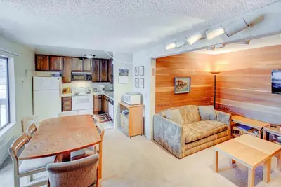 a living room with a couch and a table at Sherwin Villas #63 Private Deck & Near Lakes in Mammoth Lakes