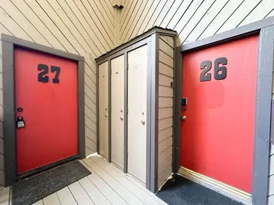 two red doors with numbers on them in a building at Sherwin Villas Retreat DT in Mammoth Lakes