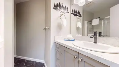 a bathroom with a sink and a mirror at Sherwin Villas Retreat DT in Mammoth Lakes