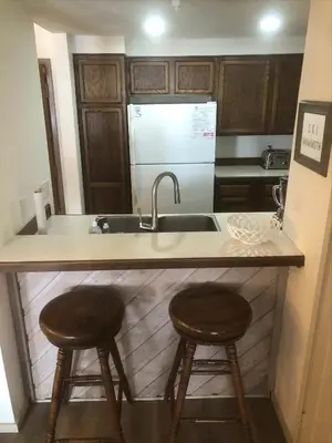 a kitchen with two stools at a kitchen counter at Aspen Creek #114 Near Year-Round Activities in Mammoth Lakes