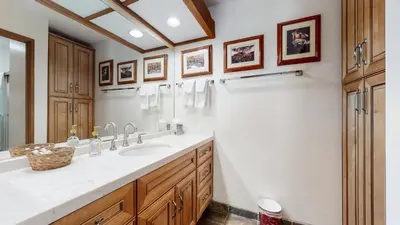a bathroom with a double sink and a shower at Aspen Creek #215 Hot Tubs Near Golf & Hiking in Mammoth Lakes