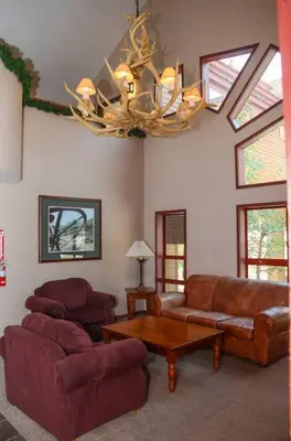 a living room with couches and a chandelier at Aspen Creek #215 Hot Tubs Near Golf & Hiking in Mammoth Lakes