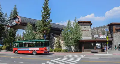 a red and green bus driving under a bridge at Aspen Creek #226 Year-Round Activities in Mammoth Lakes