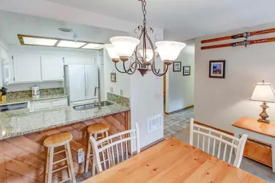 a kitchen and dining room with a table and chairs at Aspen Creek #226 Year-Round Activities in Mammoth Lakes