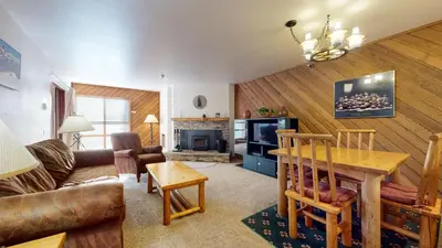a living room with a couch and a table at Aspen Creek Shared Amenities Near Hiking in Mammoth Lakes