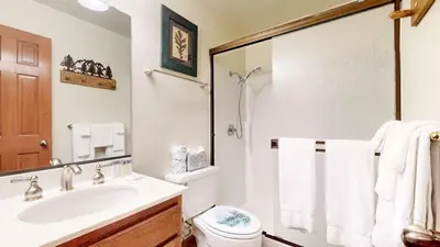 a white bathroom with a sink and a toilet at Walk to Mammoth Ski Lifts at Canyon Lodge Condo in Mammoth Lakes