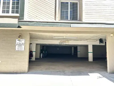a parking garage with a sign in front of a building at Walk to Mammoth Ski Lifts at Canyon Lodge Condo in Mammoth Lakes