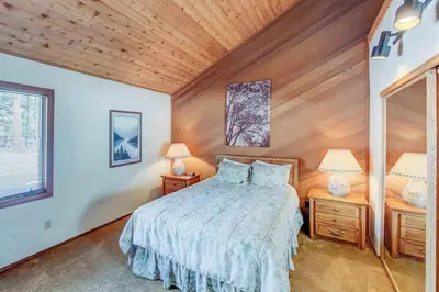 a bedroom with a bed and two night stands with lamps at Canyon Ski & Racquet #1 Near Hike & Bike Trails in Mammoth Lakes