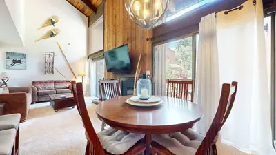 a living room with a wooden table with a candle on it at Canyon Ski Gateway Condo for 4 in Mammoth Lakes