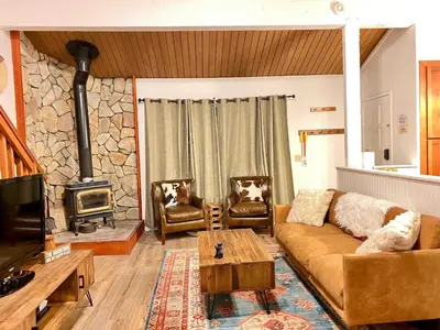 a living room with a couch and a wood stove at Sierra Manors #098 Nearby Hike & Bike Trails in Mammoth Lakes