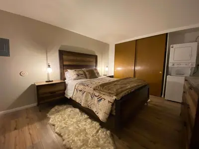 a bedroom with a bed and a dresser with a lamp at Sierra Manors #098 Nearby Hike & Bike Trails in Mammoth Lakes