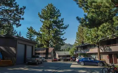 a parking lot with cars parked in front of a building at Sierra Manors #098 Nearby Hike & Bike Trails in Mammoth Lakes