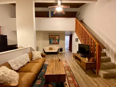 a living room with a couch and a tv at Sierra Manors #098 Nearby Hike & Bike Trails in Mammoth Lakes