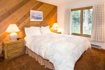 a bedroom with a large bed and a window at Snowcreek #059 Near Shuttle & Activities in Mammoth Lakes