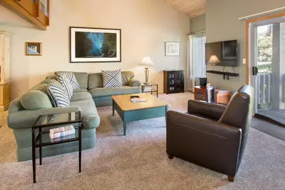 a living room with a couch and a table at Snowcreek #566 Near Golf & Shuttle in Mammoth Lakes
