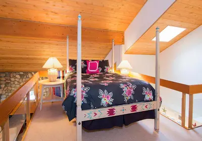 a bedroom with a bed and a table with a lamp at Snowcreek #630 Near Lakes & Golf in Mammoth Lakes